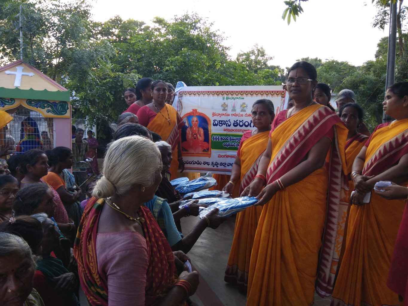 Vikasatarangini Gampalagudem Distributed 150 pair of slippers to poor old people