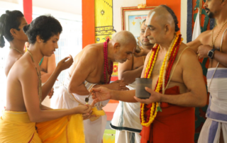 Devotees participating in Theertha Goshti and receiving sacred Theertham at Jeeyar Ashram